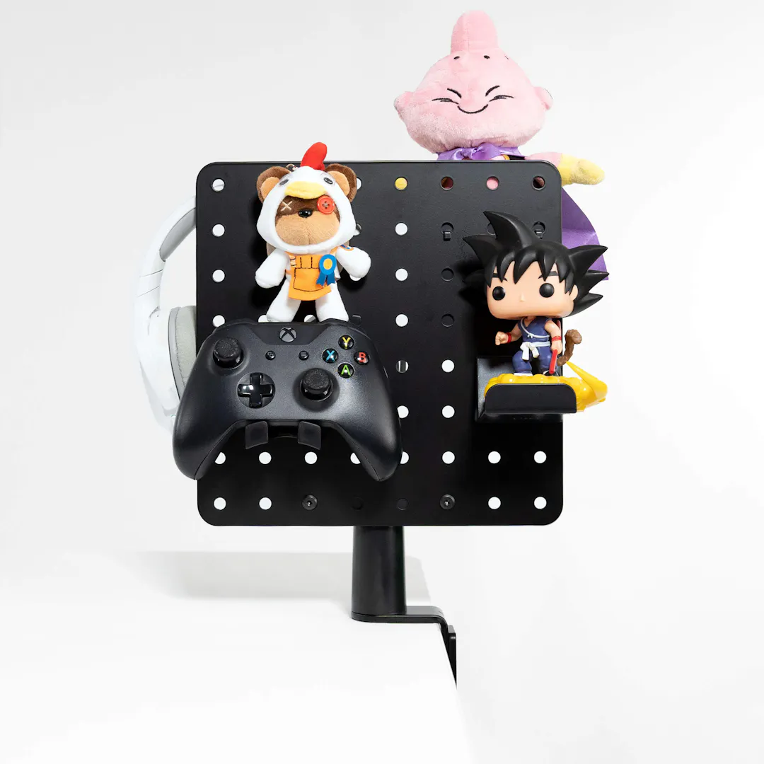 Perforated panel as a gaming and anime organiser with Xbox controller, headphones, and popular otaku figurines for space-saving storage and decoration in the anime and gaming setup.