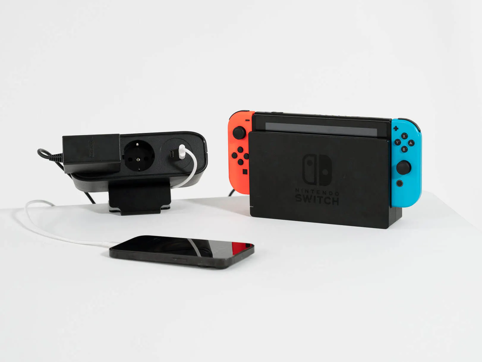 LeetDesk PowerFlak clamp-on socket used for charging a gaming console and mobile phone.