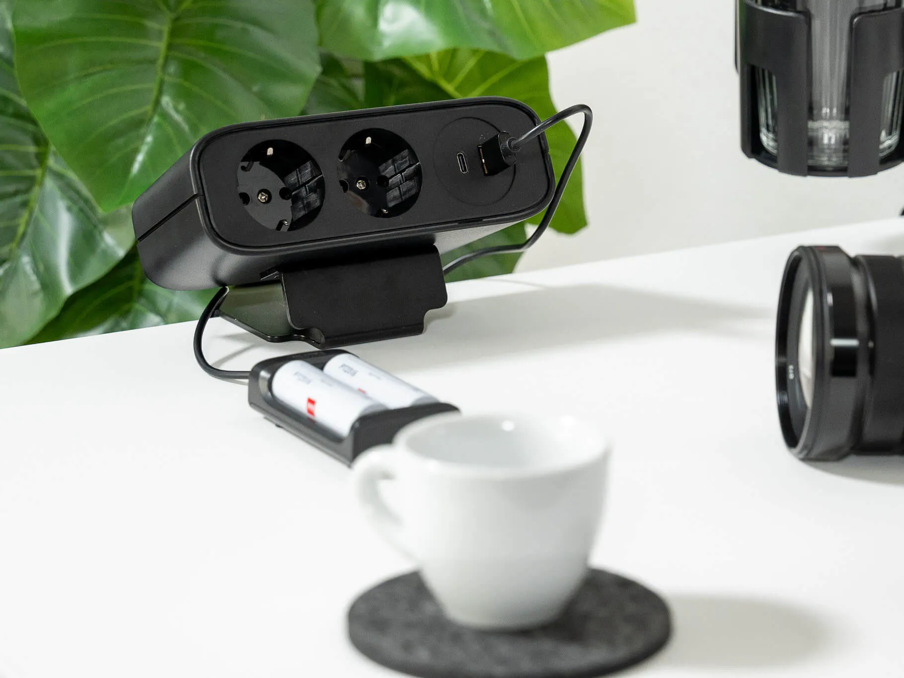 LeetDesk PowerFlak clamp-on socket providing power for camera charging on a standing desk.
