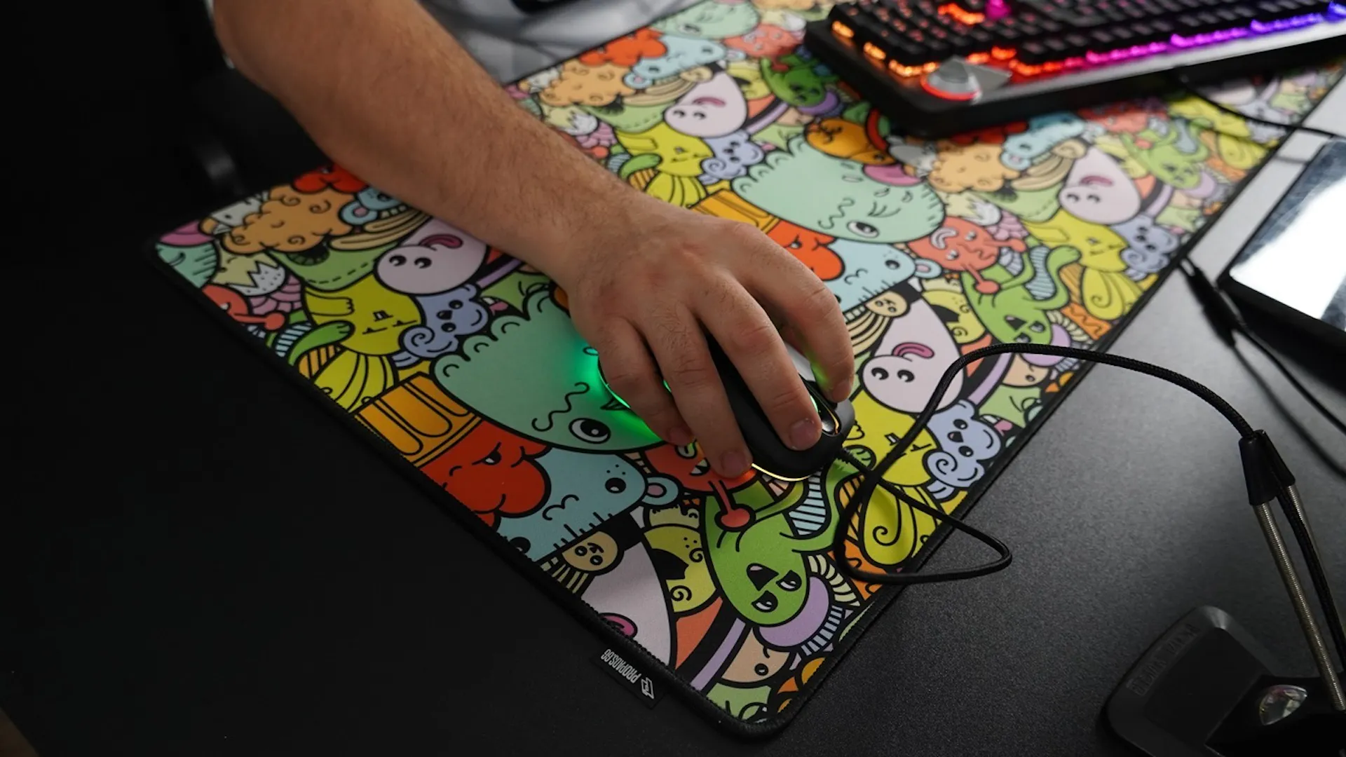 Ein buntes Mauspad mit vielen lustigen Charakteren wird zum Streamen benutzt.